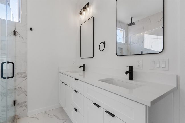 Walkin shower, light marble finish floors, and double vanity | Image 5