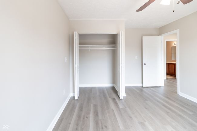 unfurnished bedroom with a closet, light wood-style floors, and a ceiling fan | Image 20