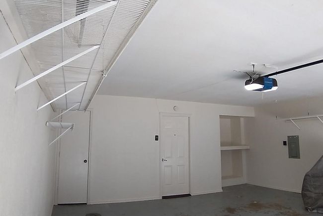 Garage with electric panel and a garage door opener | Image 7