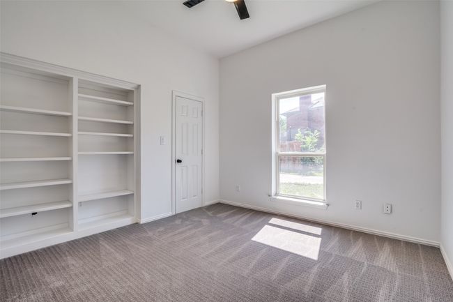 Unfurnished bedroom featuring carpet, baseboards, two closets, and ceiling fan | Image 19