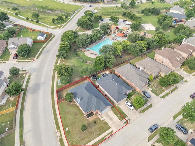 Aerial view of residential area featuring property boundaries highlighted and a pool area | Image 9