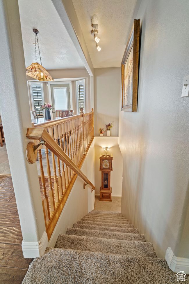 Stairs featuring a textured ceiling and baseboards | Image 19