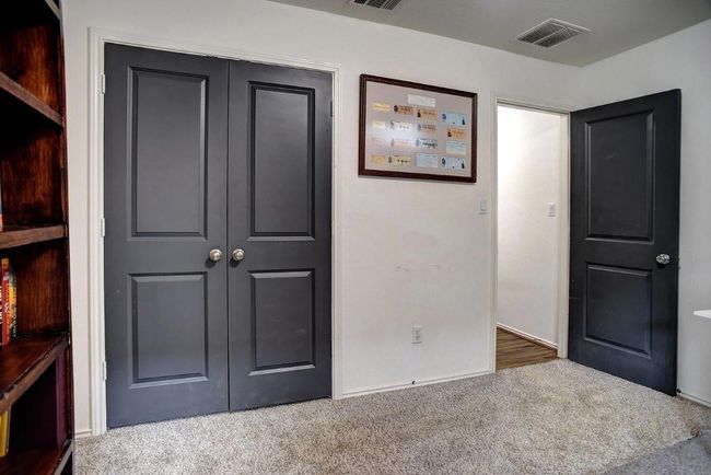 Unfurnished bedroom with visible vents, carpet floors, and a closet | Image 26