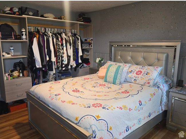 Bedroom with wood finished floors and a closet | Image 10