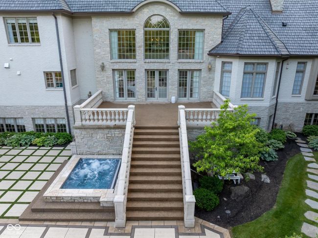 access from Great Room to Porch and outdoor area, featuring hot tub, pool fireplace and playground. | Image 95