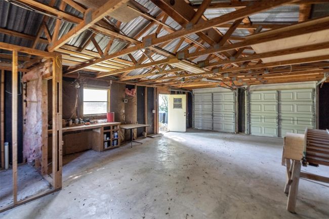 Garage with a workshop area | Image 27