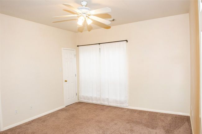 Unfurnished bedroom featuring light colored carpet and a ceiling fan | Image 14