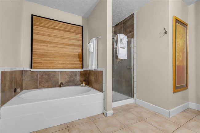 Primary bathroom with a garden tub and separate shower. | Image 29