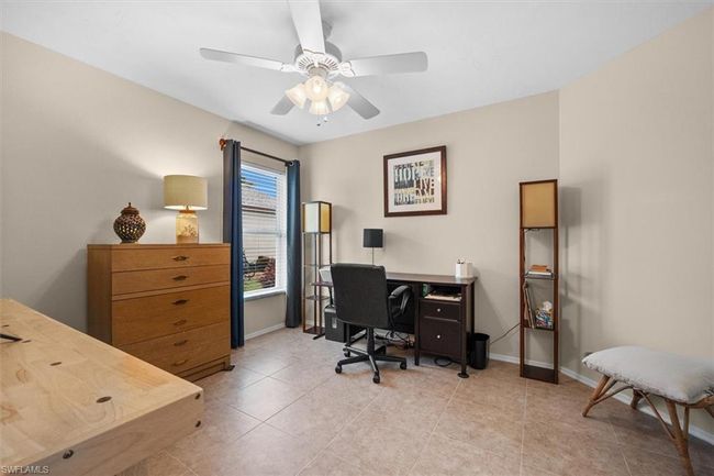 Office featuring light tile patterned floors, ceiling fan, and baseboards | Image 11