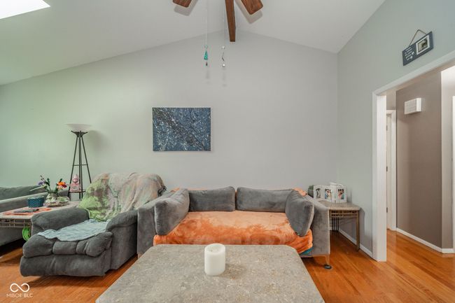 living room with wood finished floors and ceiling fan | Image 10