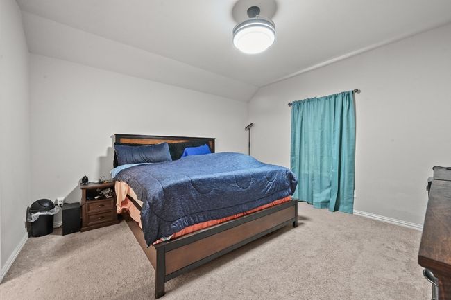 Carpeted bedroom with vaulted ceiling. | Image 21
