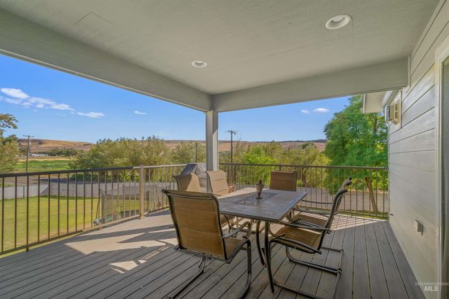 Deck featuring outdoor dining area and a lawn | Image 13