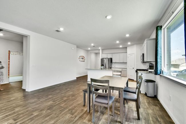Dining space with recessed lighting, dark wood-type flooring, and baseboards | Image 12