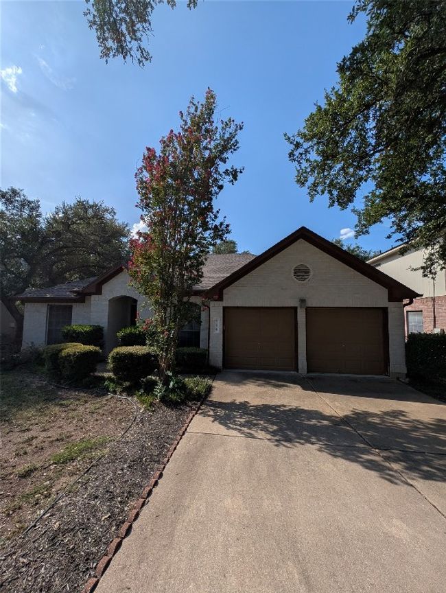 Ranch-style home featuring a garage and driveway | Image 24