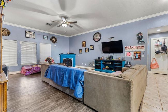 Living room with hardwood / wood-style flooring, ceiling fan, and ornamental molding | Image 5