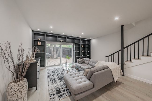 Living room featuring recessed lighting, light wood-style floors, baseboards, and stairs | Image 6