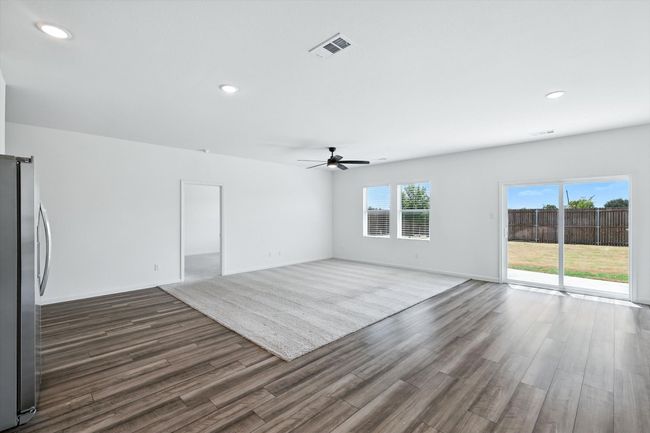 Unfurnished living room with recessed lighting, dark wood-type flooring, and a ceiling fan | Image 10