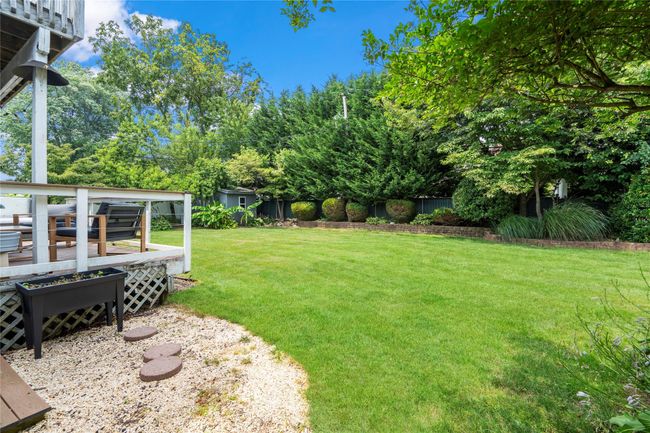 Deck featuring a hot tub, a fenced backyard, and an outdoor living space | Image 33