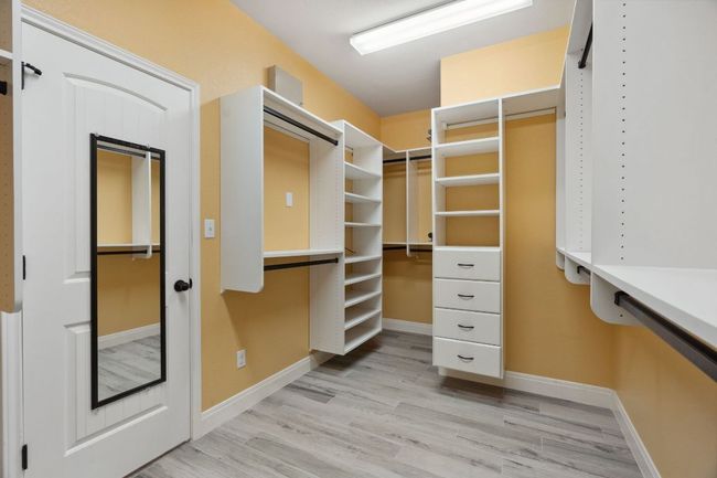The large primary closet features California Closet built-ins. | Image 23