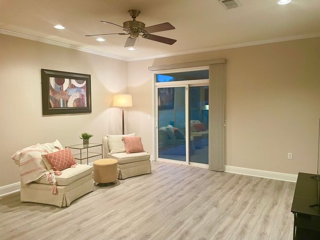 Sitting room with wood finished floors, ceiling fan, recessed lighting, and ornamental molding | Image 9