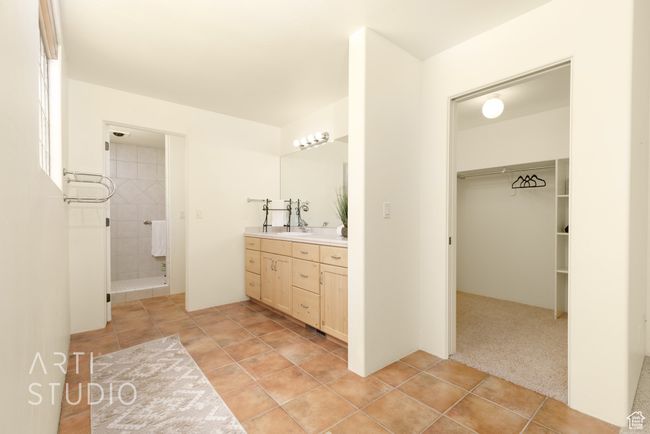Bathroom with double vanity, a sink, a spacious closet, and tiled shower | Image 28