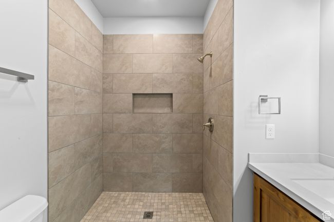 Full bath with toilet, a tile shower, and vanity | Image 32