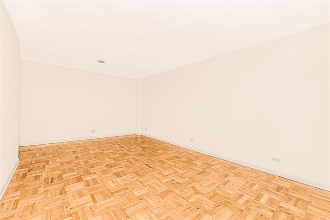 Empty room featuring radiator heating unit and baseboards | Image 15