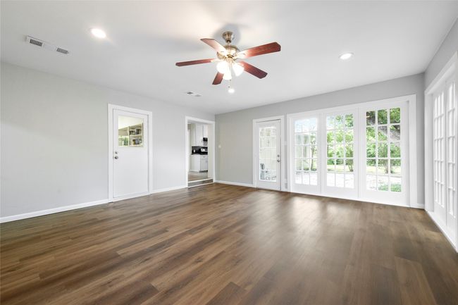 Unfurnished living room featuring ceiling fan, dark wood-style floors, and recessed lighting | Image 36