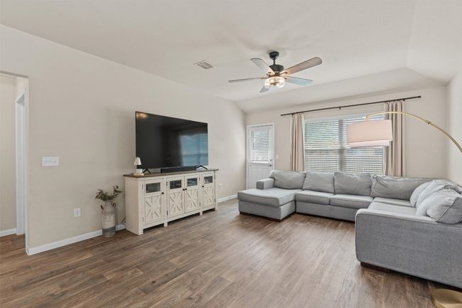 Living room featuring a ceiling fan and wood finished floors | Image 11
