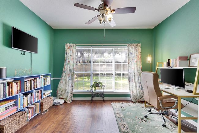 Home office with a ceiling fan, wood-type flooring, and baseboards | Image 14