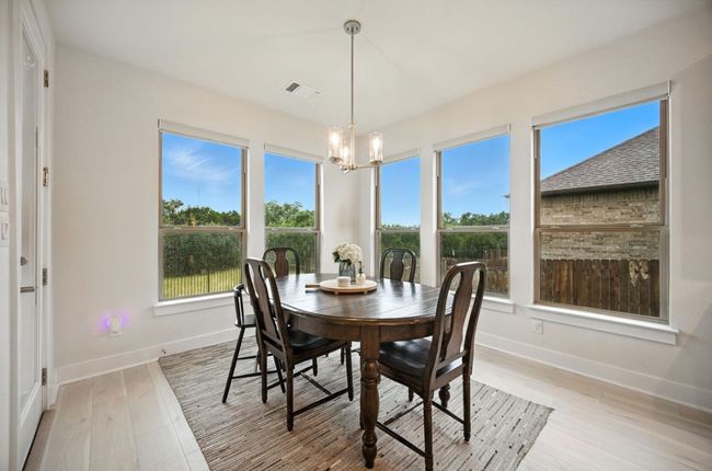 Dining space with a chandelier, plenty of natural light, and light wood-type flooring | Image 15
