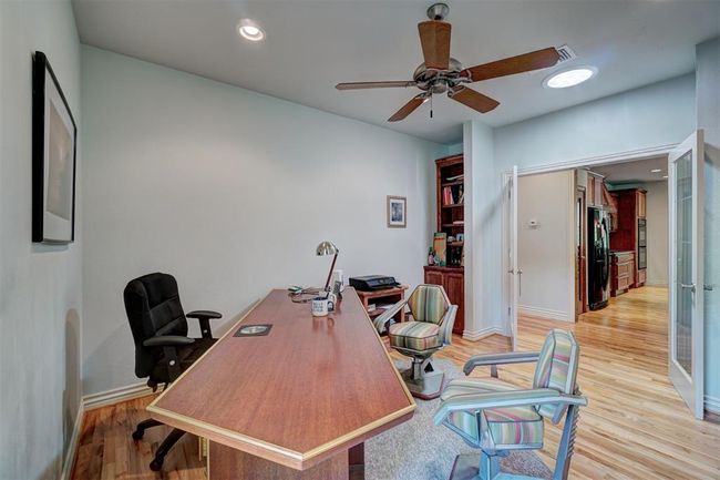 Office area featuring baseboards, a ceiling fan, french doors, and light wood finished floors | Image 20