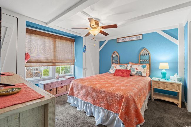 Bedroom with beam ceiling, ceiling fan, and carpet floors | Image 15