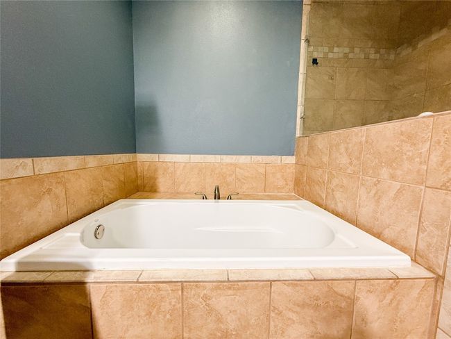 Full bathroom featuring a bath | Image 26