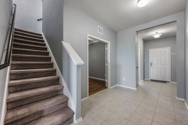 Stairs with baseboards, tile patterned flooring, and visible vents | Image 24