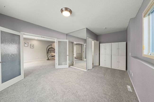 French door into the lower level bedroom | Image 38