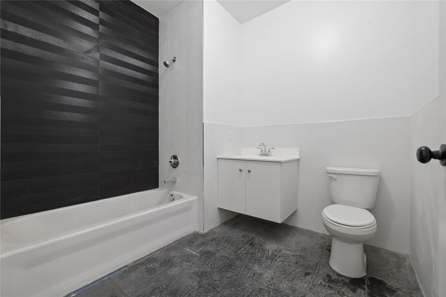 Bathroom featuring vanity, toilet, and bathing tub / shower combination | Image 20