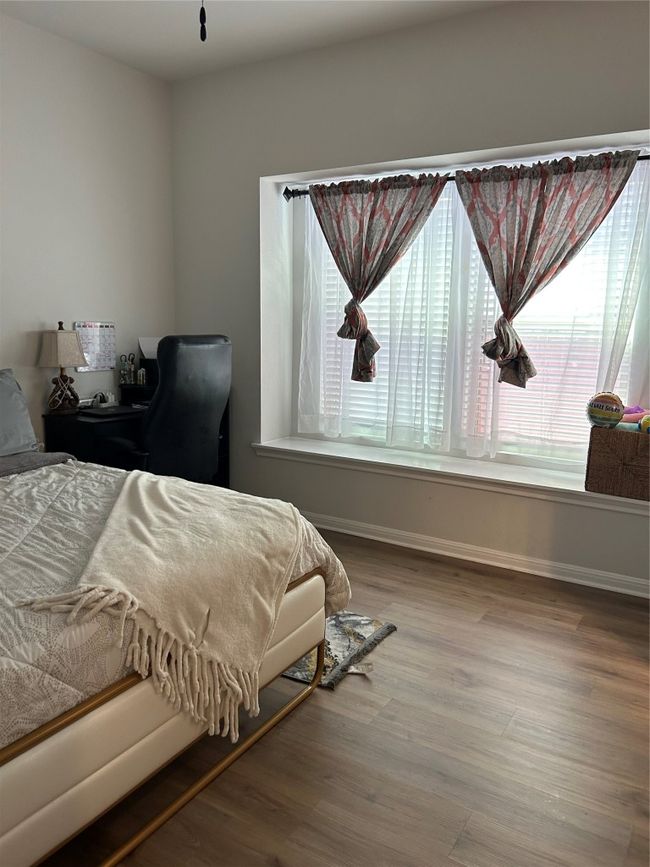 Bedroom featuring baseboards and wood finished floors | Image 17