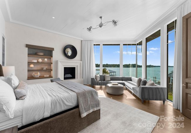 Expansive lake views, sitting area, and a cozy fireplace. Features shiplap ceilings, crown molding, and custom built-in shelves. | Image 18