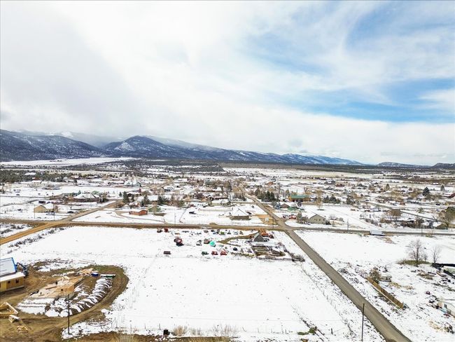 Snowy aerial view featuring a mountain view | Image 9