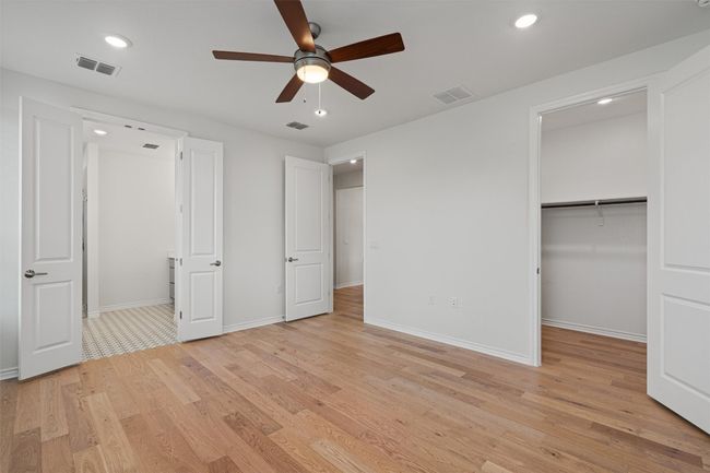 The primary bedroom with double doors to the primaryh bath and the other door leads to the large, walk-in closet | Image 12