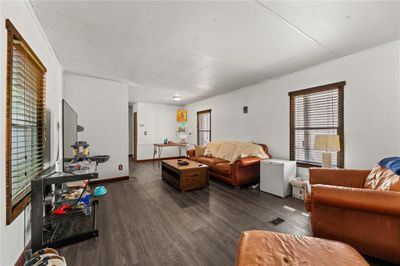 Living room featuring a healthy amount of sunlight and hardwood / wood-style flooring | Image 3