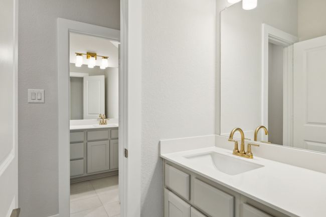 Bathroom with vanity, tile patterned flooring, and a textured wall | Image 22
