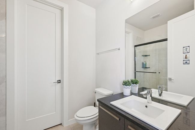 Full bathroom featuring vanity, a stall shower, and tile patterned floors | Image 21