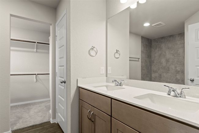 Bathroom featuring wood finished floors, double vanity, and a walk in closet | Image 26