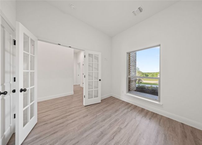 Empty room featuring french doors, wood finished floors, and baseboards | Image 6