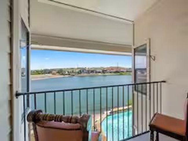 Balcony with a water view and view of pool | Image 20