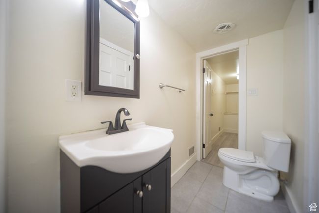 Bathroom featuring tile patterned floors, vanity, and toilet | Image 11