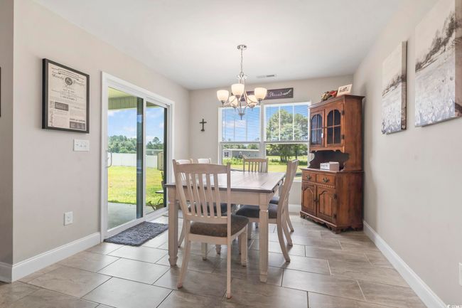 Dining space with a chandelier and baseboards | Image 9