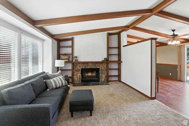 Living room with wainscoting, a fireplace, and carpet flooring | Image 5